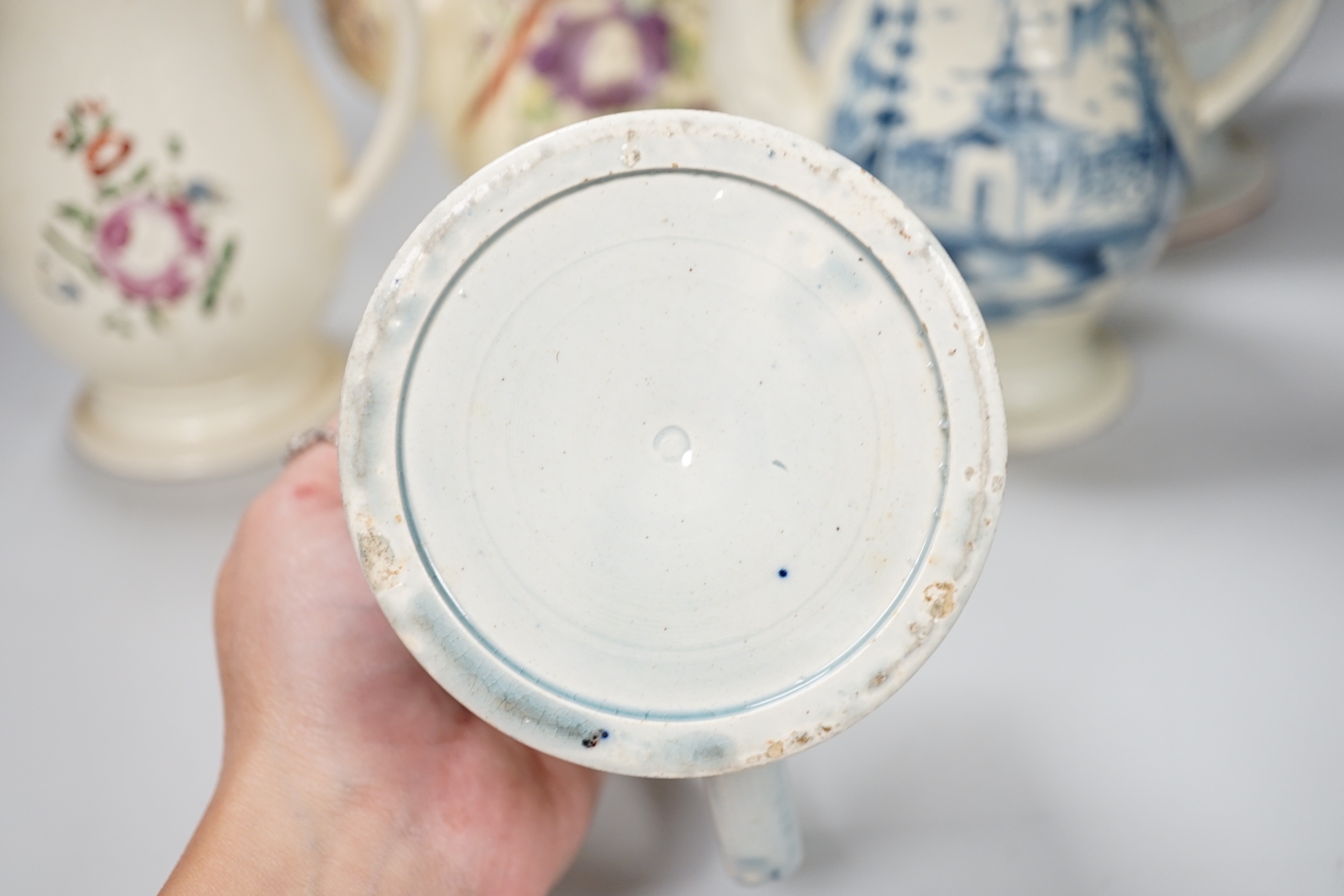 Three Georgian creamware and pearlware teapots, a jug and a mug, tallest 27cm
